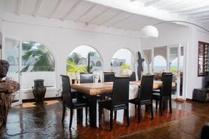a dining room with a table and chairs at Charming Penthouse -Holidays Houses in Malindi