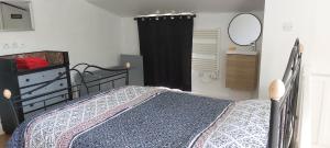 a bedroom with a bed and a black curtain at Le gîte des Allains in Sainte-Suzanne-en-Bauptois
