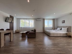 a bedroom with a bed and a couch and a table at Ancient well in Sozopol +199 photos