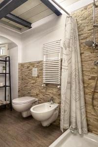 a bathroom with a sink and a toilet and a shower curtain at Ai Foggiali in Matera +14 photos