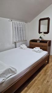 a bedroom with a large bed and a mirror at Sunshine Apartments Podstrana in Podstrana