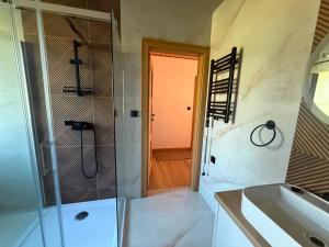 a bathroom with a shower and a sink at Widokówka in Baligród +14 photos