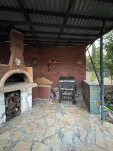 a patio with an outdoor oven and a grill at Seaside Garden Galaxidi in Galaxidi