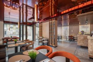 a restaurant with tables and chairs and a bar at PLATINUM hotel & spa in Sarajevo
