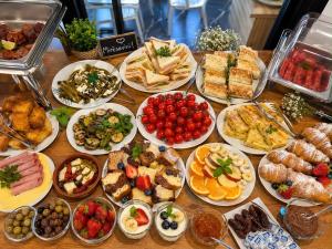 a table full of different types of food on plates at Sorean HOTEL in Ksamil