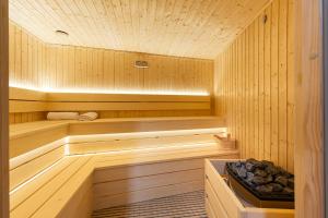 a sauna with wood paneled walls and a wooden floor at Lamadu Residence in Sutomore