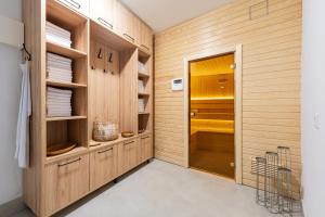 a kitchen with wooden cabinets and a door at Lamadu Residence in Sutomore