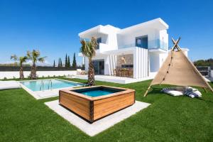 a villa with a swimming pool and a house at Martini Villas in Kremasti +37 photos