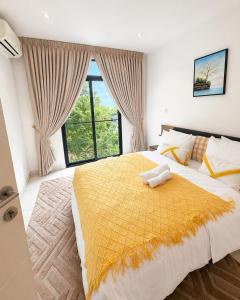 a bedroom with a large bed and a large window at EMBASSY - Sky Suites in Accra +56 photos