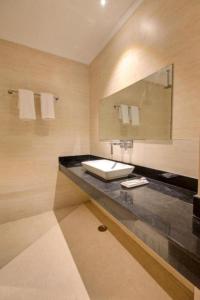 a bathroom with a sink and a mirror at Hotel Almati Inn Near IGI Delhi Airport - With Free Airport Pickup in New Delhi +17 photos