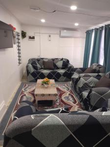 a living room with couches and a table on a rug at Coastal Paradise in Sigatoka