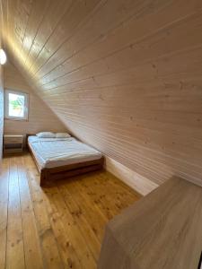 a large room with two beds in a wooden wall at Domki Nadmorska Oaza nad morzem i jeziorem in Jezierzany +68 photos
