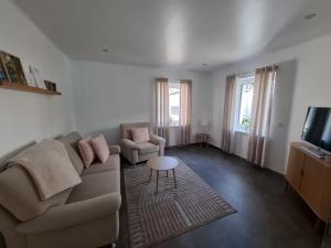 a living room with a couch and a table at FeWo MaiFlo in Briedern