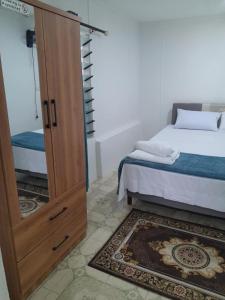 a bedroom with a wooden door next to a bed at Coastal Paradise in Sigatoka