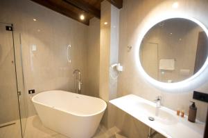 a white bathroom with a sink and a mirror at Agroturizem Prelude in (( Barç ))