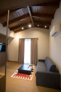 a living room with a couch and a large window at Agroturizem Prelude in (( Barç ))