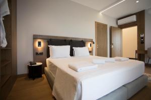 a bedroom with a large white bed with two pillows at Agroturizem Prelude in (( Barç ))