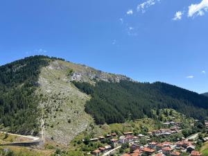 a view of a mountain with houses on it at Къща за гости Изгрев in Trigrad