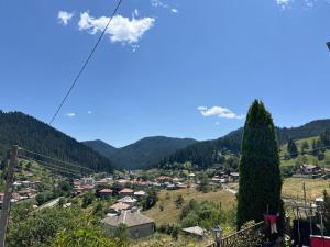 a view of a small village in the mountains at Къща за гости Изгрев in Trigrad
