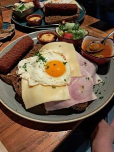 a plate of food with an egg and cheese and bread at Maria's place in Tujering