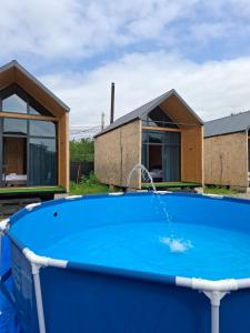 a pool with a water fountain in front of a house at AnArt resort in Vanadzor
