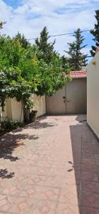 a driveway leading to a garage with a fence at Casa Villa in Baku