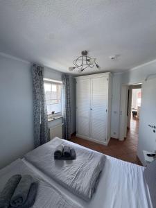 a bedroom with a bed with shoes on it at Möwennest 13 Scharbeutz in Scharbeutz