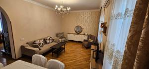 a living room with a couch and a mirror at Casa Villa in Baku +2 photos