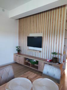 a living room with a flat screen tv on a wall at Nowy Zakątek in Paszkówka