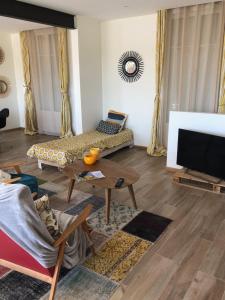 a living room with a couch and a table at Villa Maude & Jean in Lacanau-Océan