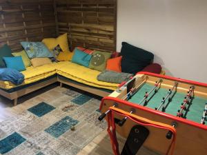 a living room with a couch and a pool table at Villa Maude & Jean in Lacanau-Océan
