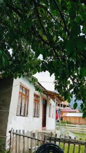 a white house with windows in front of it at Ushba Hearth House in Tvebishi