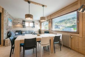 a kitchen and dining room with a table and chairs at Cozy chaleett on SLOPES in Crest-Voland