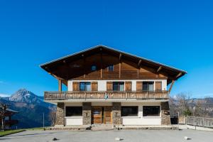 a large wooden building with a balcony at Cozy chaleett on SLOPES in Crest-Voland