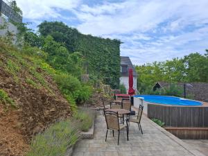 a patio with chairs and a table and a pool at Smartliving 85 in Aßlar