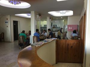 a group of people sitting at a counter in a restaurant at KOÇAN OTEL Hatice Karakoçan in Akçakoca