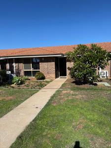 a brick building with a sidewalk in front of it at Entire 2 bedrooms unit in Geraldton