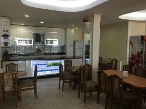 a restaurant with tables and chairs and a kitchen at KOÇAN OTEL Hatice Karakoçan in Akçakoca