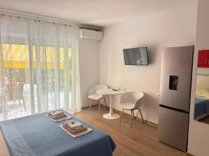a bedroom with a bed and a table with chairs at Villa Sekki in Krk