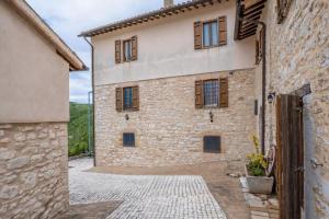 a large stone building with windows on it at House Morro di Rasiglia in Rasiglia +1 photo