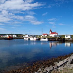 a group of boats are docked in a harbor at Hotel Nordurljos in Raufarhöfn