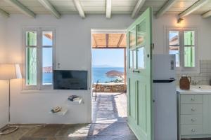 a kitchen with a door and a view of the ocean at Serifos View in Serifos Chora