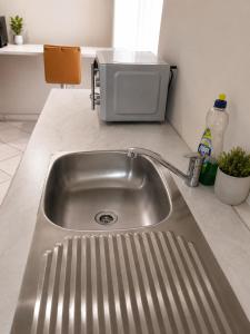 a stainless steel kitchen sink in a kitchen at Suider Ozias Self Catering in Windhoek +18 photos