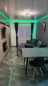 a living room with a table and a couch at Divine House Straja in Lupeni