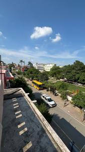 a view of a street with a yellow school bus at Inka Kashi Hostel Varanasi in Varanasi