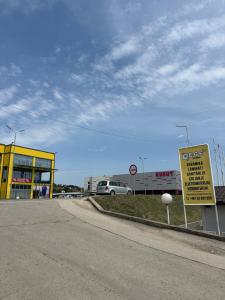 a sign on the side of a road near a gas station at Avdic Guest House in Makljenovac