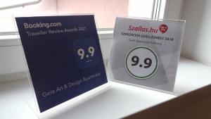 a pair of signs on a shelf in a room at Gere Art&Exclusive Apartments in Harkány