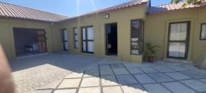 a house with a patio in front of it at Rundu Rainbow Guesthouse in Rundu +3 photos