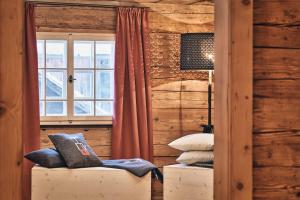 a room with a window and a chair in a room at Wald 12 Ferienhaus in Wald am Arlberg