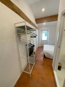 a room with a white room with a bed at SH Suite OLMO AC e Wi-Fi in Manziana